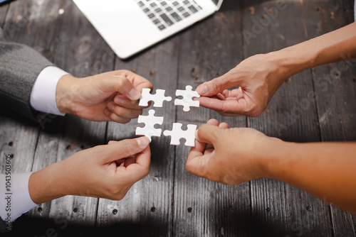 Businessman sitting at a table intently completing a jigsaw puzzle, demonstrating problem-solving, strategic thinking, and business decision-making, as well as attention to detail and patience.