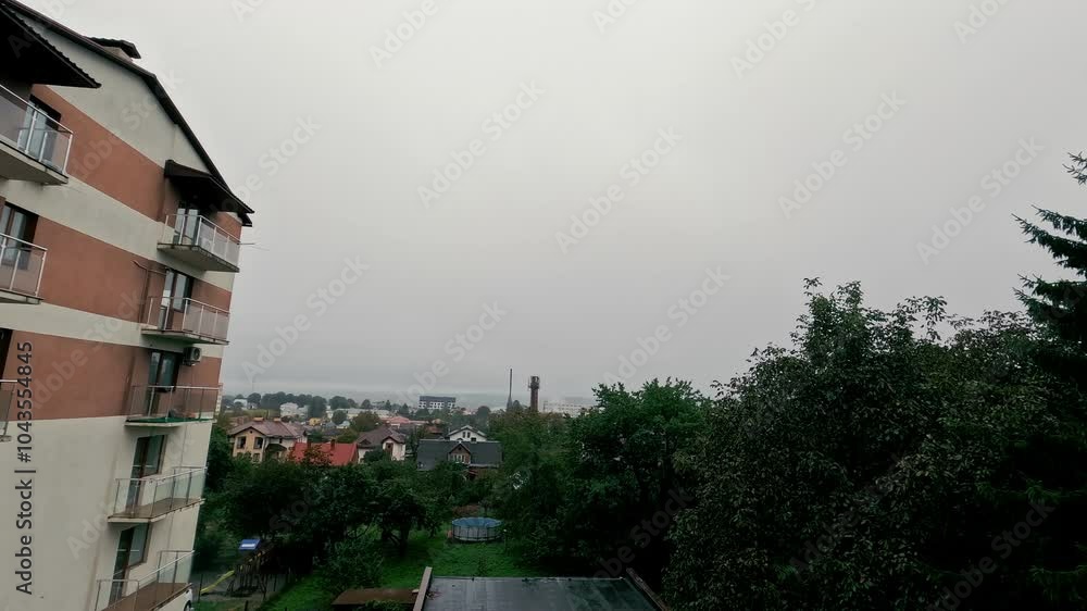 Overcast suburban view with apartment building and trees, A cloudy day overlooking a suburban neighborhood, featuring an apartment building Overcast suburban view with apartment building and trees, A cloudy day overlooking a suburban neighborhood, featuring an apartment building