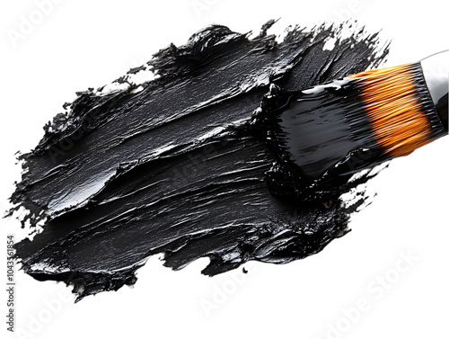 Close-up of a brush applying smooth black paint on a white background. photo