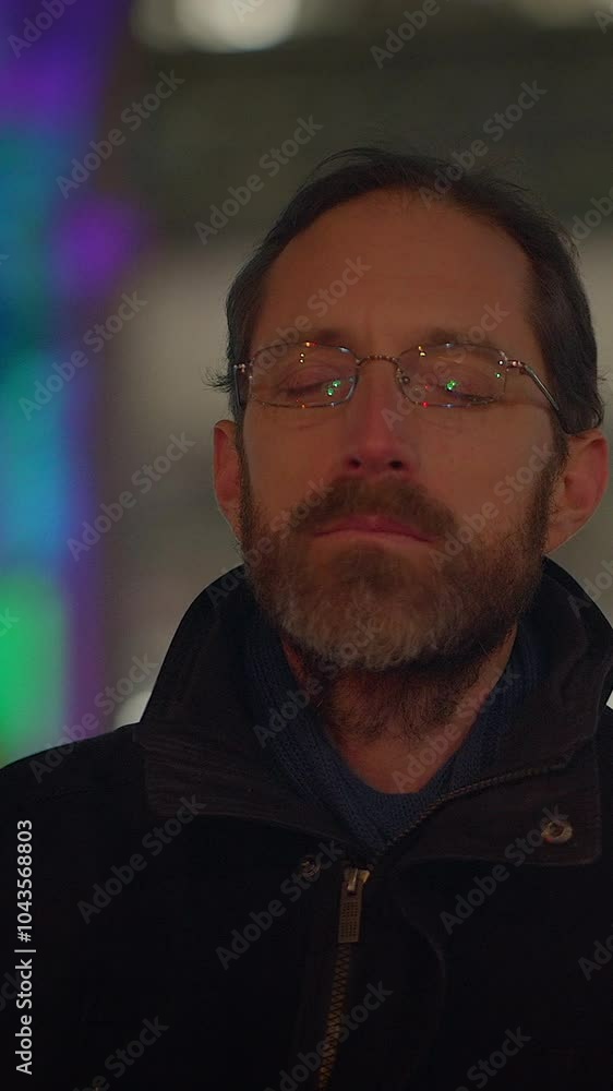 A thoughtful man stands in a vibrant urban night scene, surrounded by colorful twinkling lights A thoughtful man stands in a vibrant urban night scene, surrounded by colorful twinkling lights
