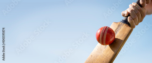 Cricket player batsman background hitting ball with a cricket bat shot from below
