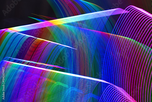 A colorful, abstract image with a rainbow of colors. The image is a representation of a wave, with the colors blending together to create a sense of movement and energy. Scene is one of excitement