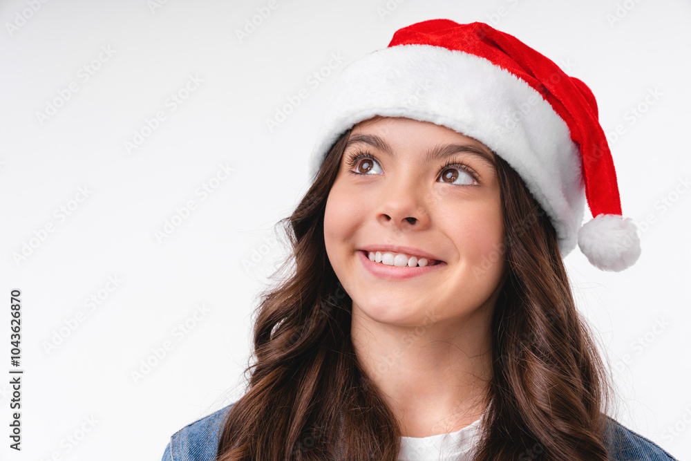 Closeup cropped shot of caucasian teenage young girl with toothy smile in Santa`s hat celebrating winter holidays isolated over white background. Merry Christmas and Happy New Year! Closeup cropped shot of caucasian teenage young girl with toothy smile in Santa`s hat celebrating winter holidays isolated over white background. Merry Christmas and Happy New Year!