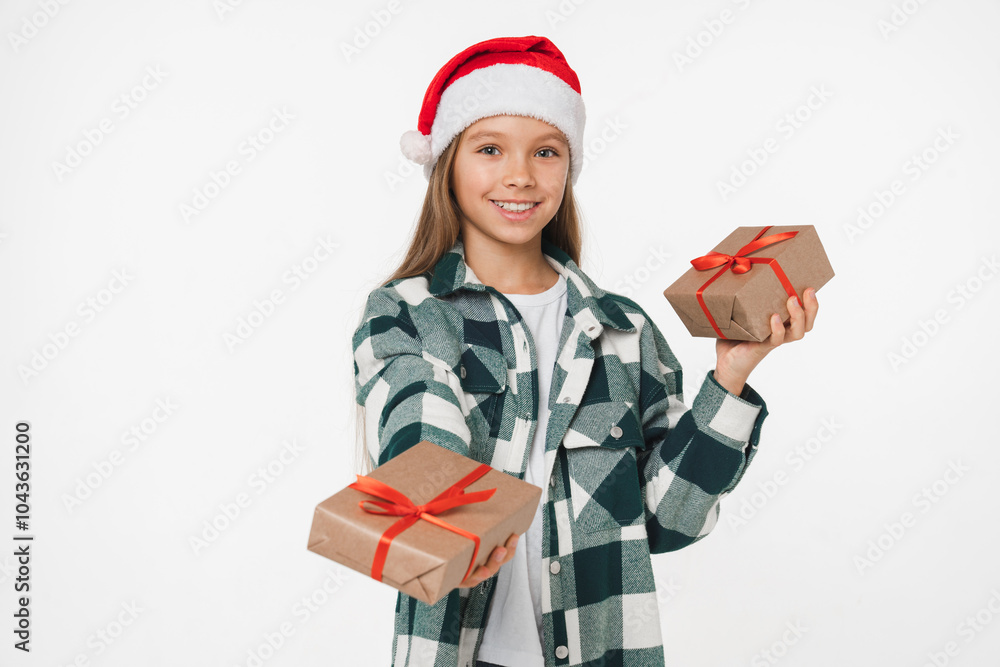 Happy caucasian young preteen teenage girl in red Santa Claus hat giving receiving Christmas New Year presents gifts isolated in white background. Winter holidays concept Happy caucasian young preteen teenage girl in red Santa Claus hat giving receiving Christmas New Year presents gifts isolated in white background. Winter holidays concept