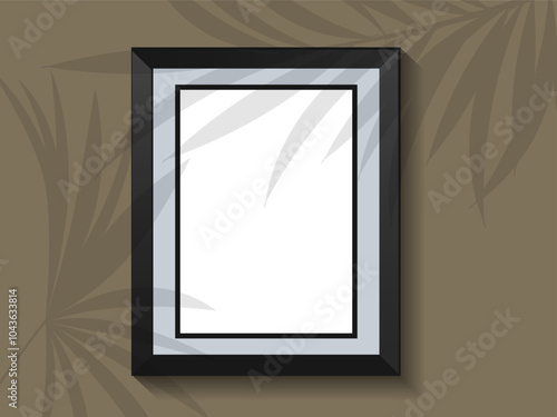 picture frame on wall with shadow overlay of tropical leaves.