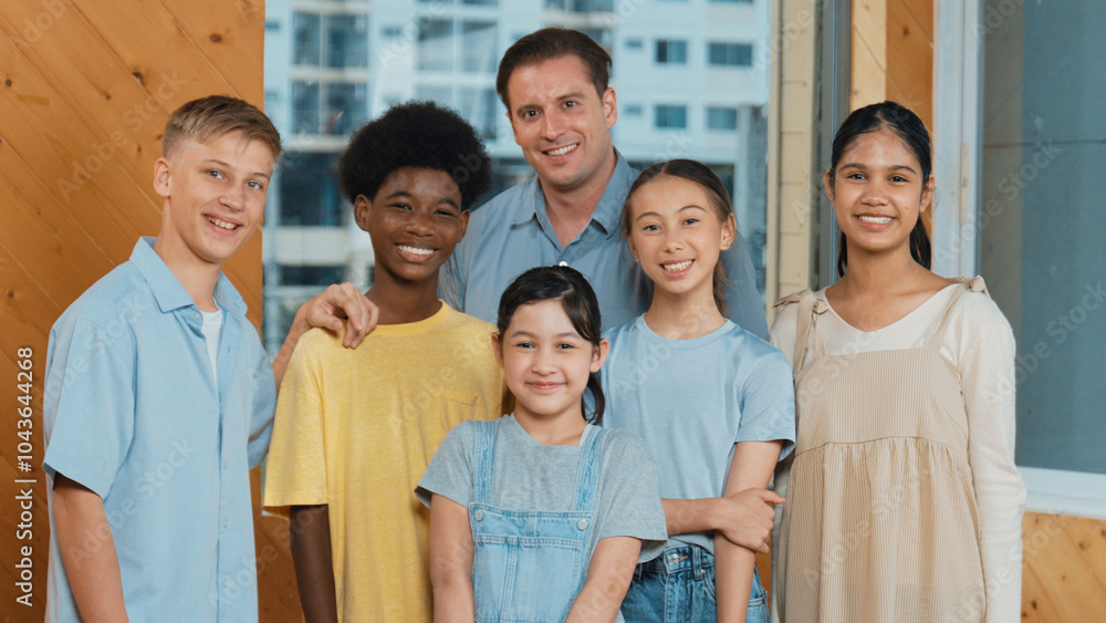 Happy teacher and diverse student standing while smilling to camera. Professional smart instructor with highschool children with mixed races in casual outfit pose at camera with cheerful. Edification. Happy teacher and diverse student standing while smilling to camera. Professional smart instructor with highschool children with mixed races in casual outfit pose at camera with cheerful. Edification.