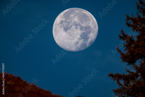 at sunrise on the mountains and the super full moon goes down, at a autumn morning photo