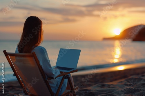 Woman Working on Laptop at Sunset Beach