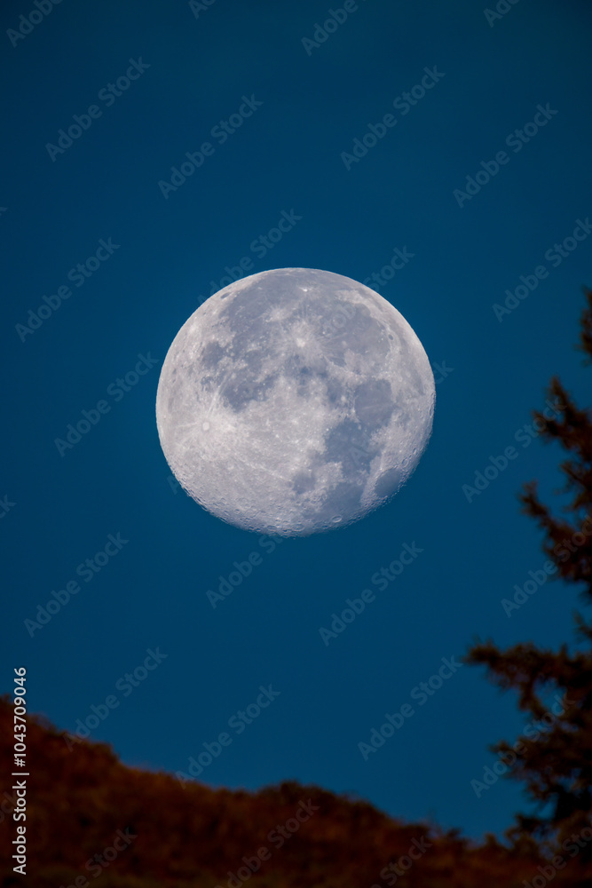 at sunrise on the mountains and the super full moon goes down, at a autumn morning at sunrise on the mountains and the super full moon goes down, at a autumn morning