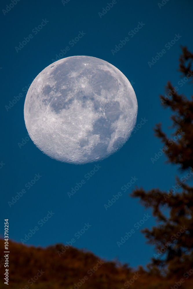 at sunrise on the mountains and the super full moon goes down, at a autumn morning at sunrise on the mountains and the super full moon goes down, at a autumn morning