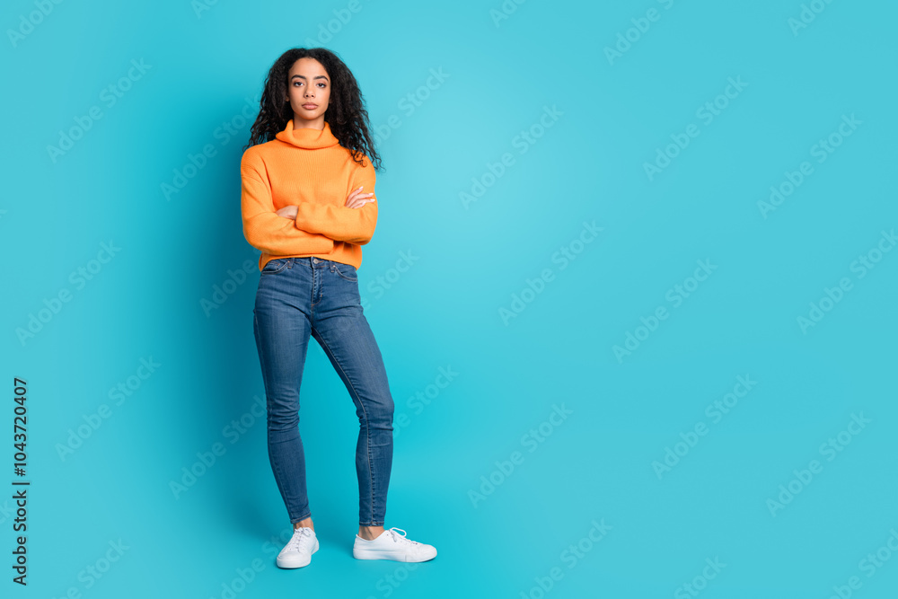 Full length photo of confident pretty teen lady dressed orange turtleneck arms crossed empty space isolated blue color background Full length photo of confident pretty teen lady dressed orange turtleneck arms crossed empty space isolated blue color background