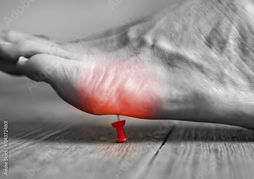Konstfotografi Pin poking into the bottom of a person's foot with red pain area