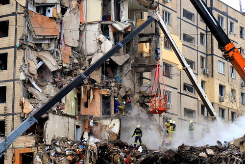 Russian missile strike destroyed residential building, Dnipro, Ukraine. Rescuers are looking for people under rubble of house, rescue equipment, fire. Russian war