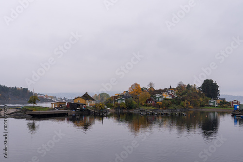 Oslo, Norway - October 20, 2024: Oslofjord (Oslofjorden), view of summer houses and cottages. Frame houses for recreation. Hut among the forest and rocks. Multicolored private houses. photo