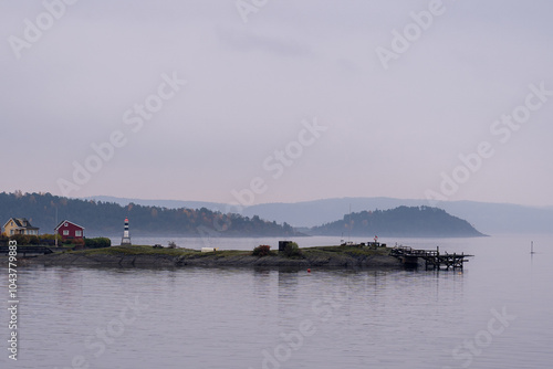 Oslo, Norway - October 20, 2024: Oslofjord (Oslofjorden), view of summer houses and cottages. Frame houses for recreation. Hut among the forest and rocks. Multicolored private houses. photo