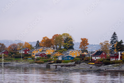 Oslo, Norway - October 20, 2024: Oslofjord (Oslofjorden), view of summer houses and cottages. Frame houses for recreation. Hut among the forest and rocks. Multicolored private houses. photo