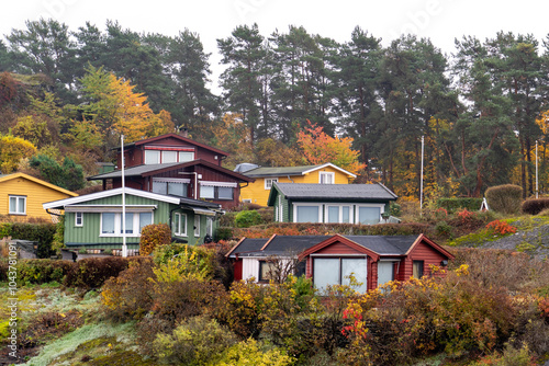 Oslo, Norway - October 20, 2024: Oslofjord (Oslofjorden), view of summer houses and cottages. Frame houses for recreation. Hut among the forest and rocks. Multicolored private houses. photo