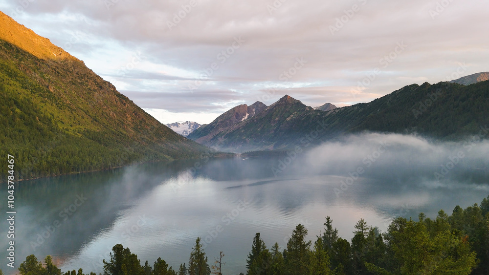Fototapeta premium flying a drone in the clouds over the Multinsky mountain lake in Altai