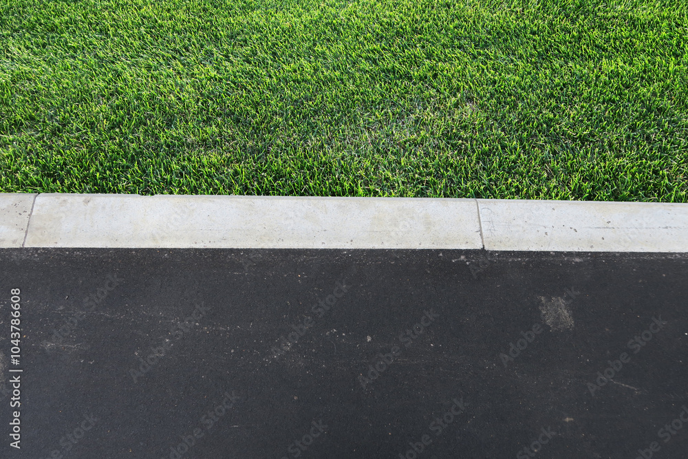 Fototapeta premium aying of sidewalks with new asphalt. Curbs enclosing the lawn, grass