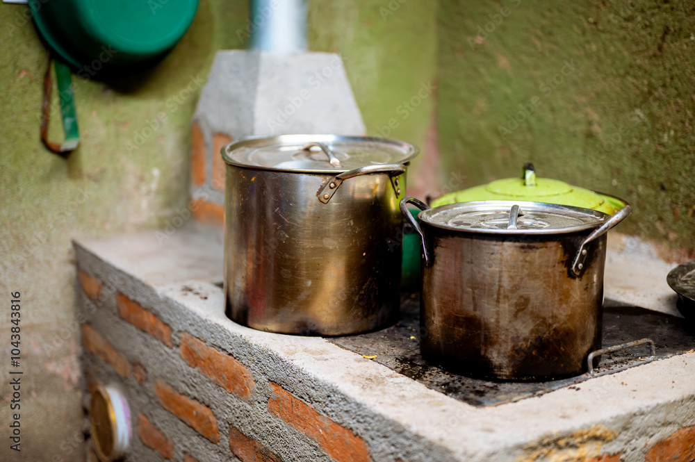 View of a homemade stove, designed to use little organic fuel with a smoke extraction system to prevent respiratory diseases in people. View of a homemade stove, designed to use little organic fuel with a smoke extraction system to prevent respiratory diseases in people.