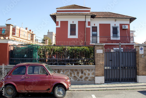 Photography Old rusty red car in front of a beautiful new house