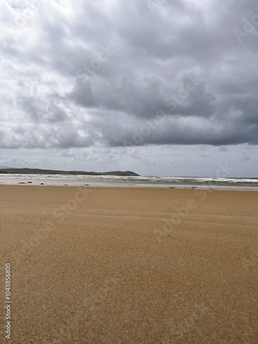 beach and sea with a hint of the rolling hills and sand dunes Ireland co Donegal 