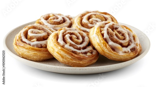 Delicious homemade cinnamon rolls with icing on a ceramic plate