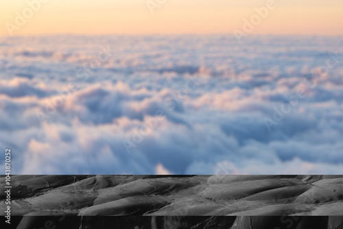 Black stone table on clody background. Product display platform with fog, smoke cloud. Dark black floor. smoky display studio. Black marble table podium with black stone floor in dark room with smoke photo