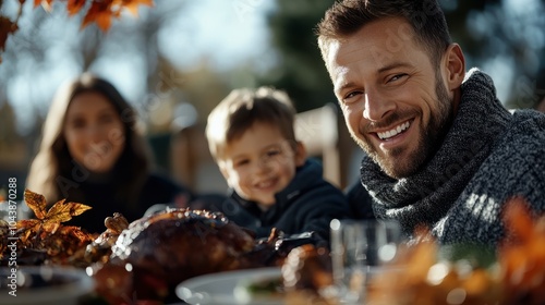 A smiling young boy sits at a festively decorated table with a roasted turkey, surrounded by family, enjoying a warm and cheerful holiday meal and companionable warmth. photo