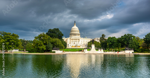 United states capitol reflected on the pool under a dramatic gray sky