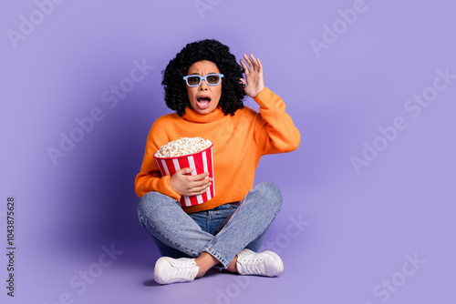 Full length photo of impressed attractive lady dressed knitted pullover watch scary movie enjoy pop corn isolated purple color background photo