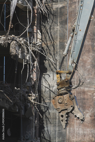 Industrial Demolition Machine Tearing Down Building with Exposed Rebar photo