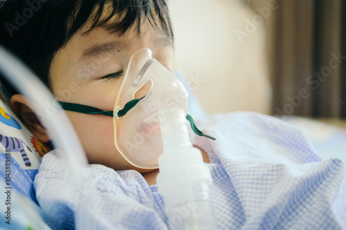 Obraz na płótnie Boy 4 years old , inhale medication by inhalation mask to cure Respiratory Syncytial Virus (RSV) on hospital bed. Admitted patient boy inhalation therapy. w salonie