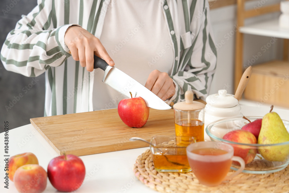 Woman cutting apples at table in kitchen Woman cutting apples at table in kitchen