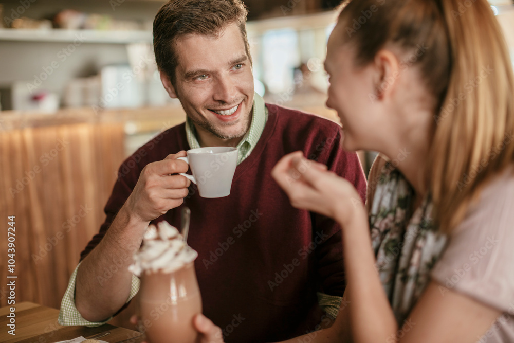 Young couple having a cup of coffee in a cafe together Young couple having a cup of coffee in a cafe together