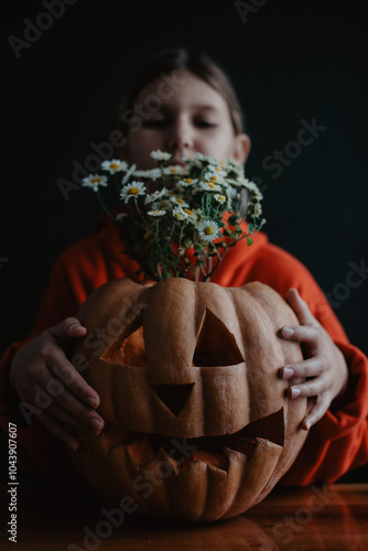 Wallpaper Mural Teenager girl holding carved Halloween pumpkin with flowers inside, close up Torontodigital.ca