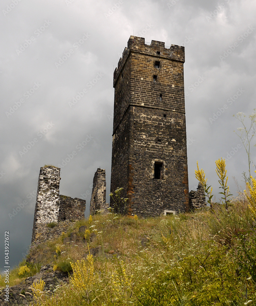 Medieval stone castle tower and cloudy sky, dramatic scene Medieval stone castle tower and cloudy sky, dramatic scene