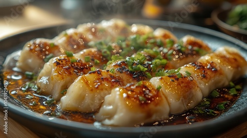 plate of steaming dumplings glistening with a rich savory sauce artfully garnished with fresh cilantro and sliced green onions exuding mouthwatering aromas and inviting taste photo