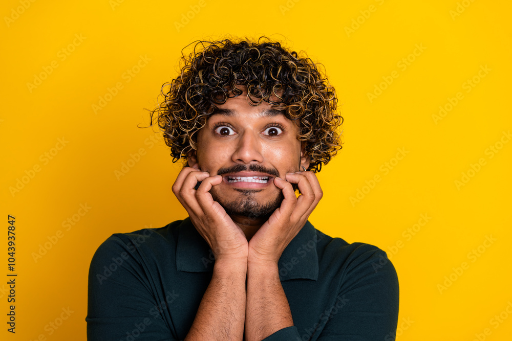Young man with expressive face showing surprise against bright yellow backdrop Young man with expressive face showing surprise against bright yellow backdrop