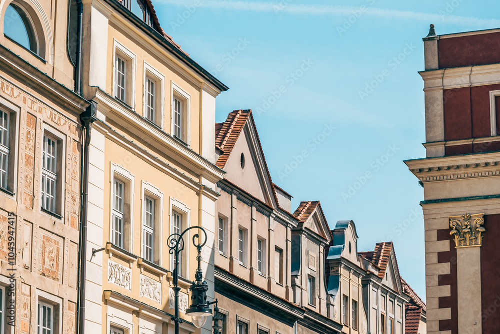 Colorful Historic Buildings and Houses on Stary Rynek Square in Poznań, Poland, with a Blue Sky and Mural Art