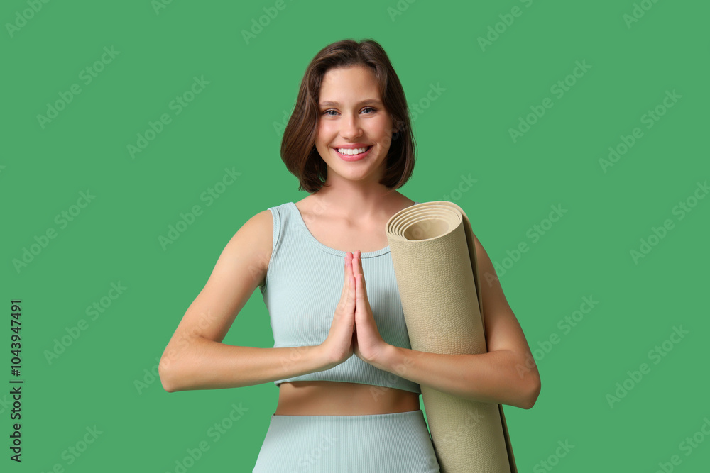 Pretty young woman with yoga mat meditating on green background Pretty young woman with yoga mat meditating on green background