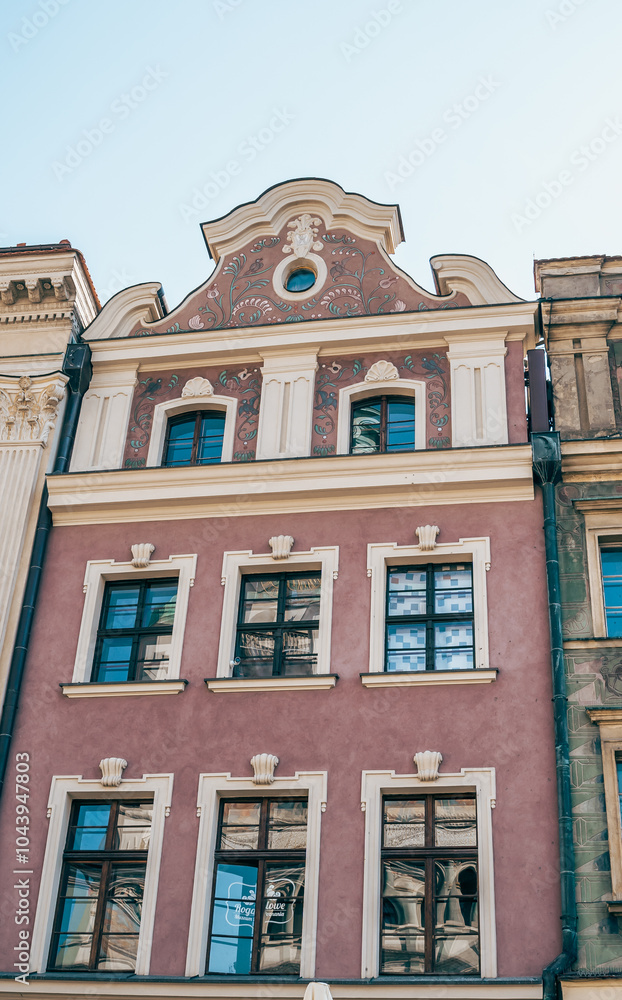 Colorful Historic Buildings and Houses on Stary Rynek Square in Poznań, Poland, with a Blue Sky and Mural Art