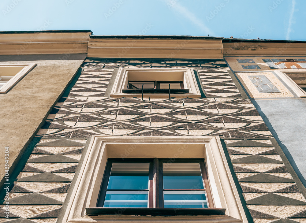 Colorful Historic Buildings and Houses on Stary Rynek Square in Poznań, Poland, with a Blue Sky and Mural Art