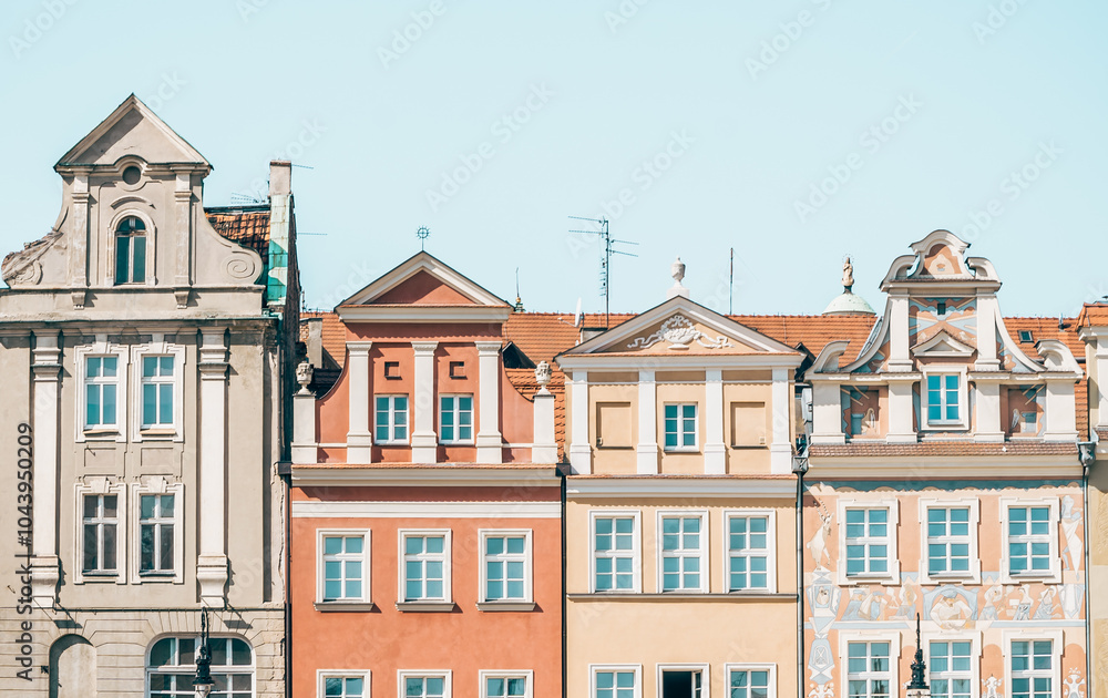 Colorful Historic Buildings and Houses on Stary Rynek Square in Poznań, Poland, with a Blue Sky and Mural Art
