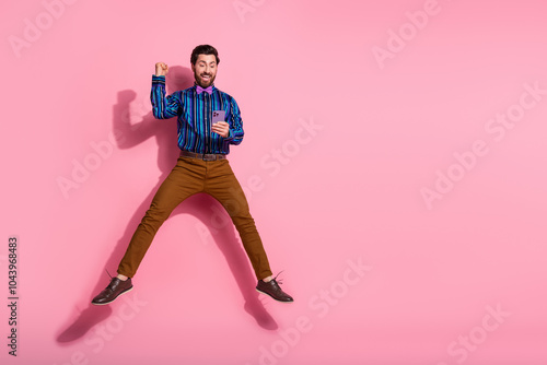 Photo of positive glad cheerful elegant man wear stylish clothes fly air empty space isolated on pink color background