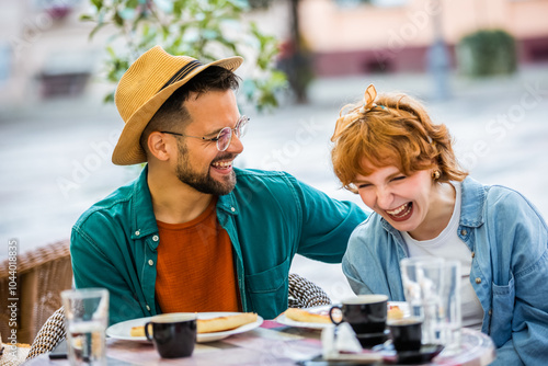 Beautiful couple sits in a restaurant and drinks coffee. Delicious pizza on the table. photo