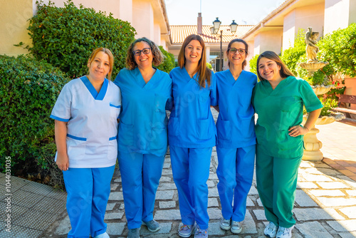 Nurses and caregivers standing outside the nursing home photo