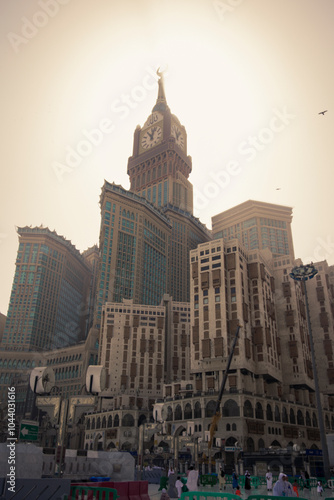 Low angle view of people walking in front of The Clock Towers in Riyadh city