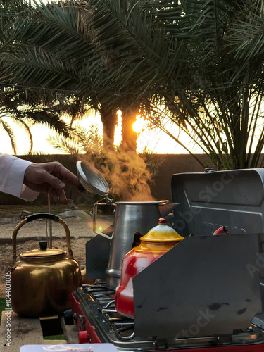 Person holding stainless steel kettle photo