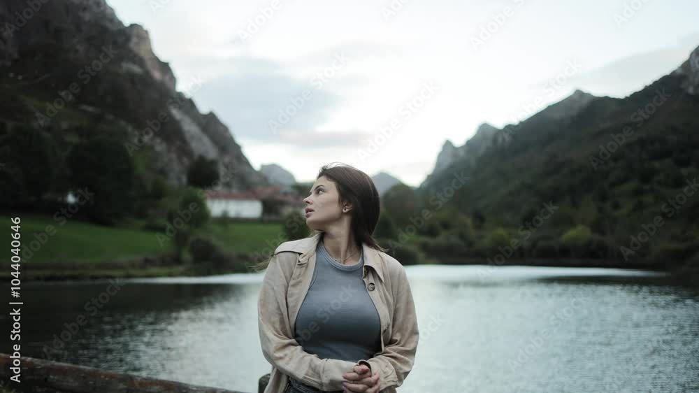 Woman enjoying a walk in the mountains near a lake, peaks, hiking, sport, outdoor activity, view, landscape, wildlife, tourism, beautiful gait of a model, dusk, season, getting cold, dark, lifestyle Woman enjoying a walk in the mountains near a lake, peaks, hiking, sport, outdoor activity, view, landscape, wildlife, tourism, beautiful gait of a model, dusk, season, getting cold, dark, lifestyle